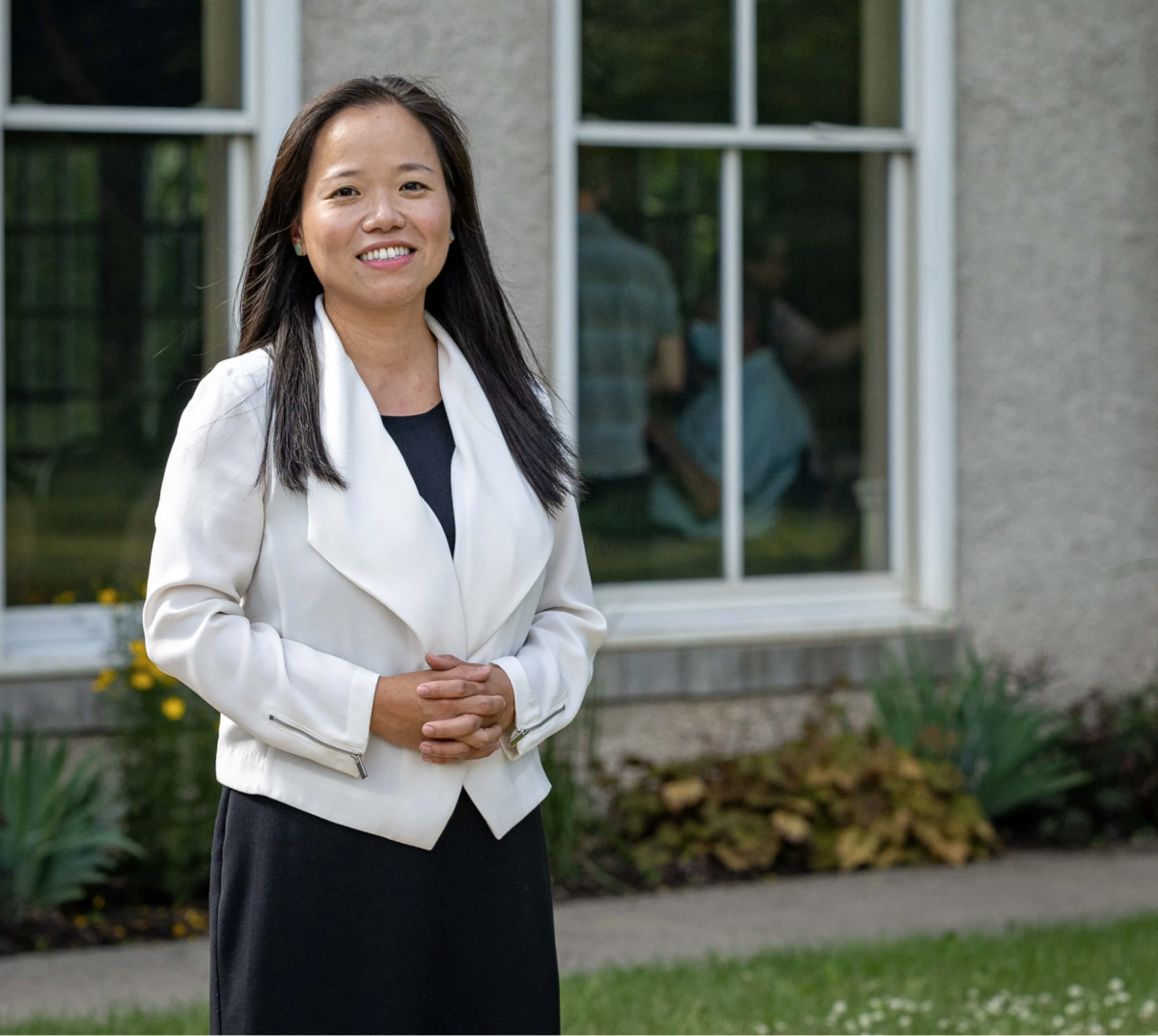 Potential DeKalb mayoral candidate Linh Nguyen stands outside a window. Nguyen will be on the ballot in April’s mayoral election if she receives 20 votes in a primary election. (Courtesy of Linh Nguyen)